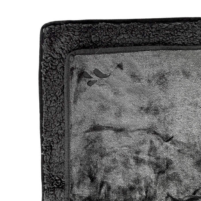 A close-up of the Splash Blanket The OG Waterproof Blanket - Large in soft dark gray fleece, featuring a plush textured border and smooth center, shown partially folded.