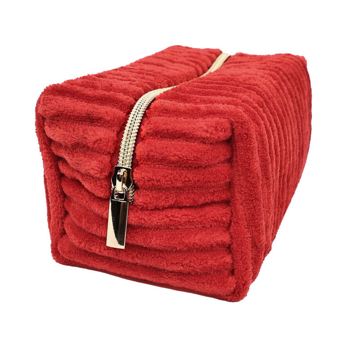 The Plush Zip Up Toy Storage Bag is a rectangular red corduroy pouch with a gold zipper, ideal for discreetly storing toys or organizing travel essentials. Shown on a white background.
