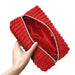A hand holds the Plush Zip Up Toy Storage Bag, featuring red textured fabric and a gold zipper, partially open to show its smooth, shiny red lining inside.