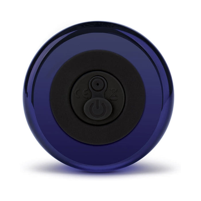 The Glas Rechargeable Remote-Controlled G-Spot & Prostate Vibrator is a circular, dark blue device with a black center and power button symbol, shown on a white background; its beginner-friendly design ensures easy use.
