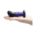 A hand holds the Glas Rechargeable Remote-Controlled G-Spot & Prostate Vibrator, a dark blue, curved glass massager with a rounded tip and raised bumps, shown against a white background.
