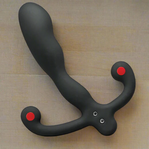 The Aneros Helix SYN V is a black, curved vibrating hands-free prostate massager with dual rounded handles featuring red tips, shown on a beige surface—ideal for intense prostate stimulation.