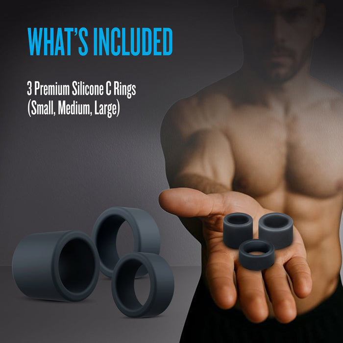 A muscular, shirtless man holds three Accelerate Thick Stretchy Black Silicone Cock Rings (Small, Medium, Large) in his outstretched hand. Text: "WHAT'S INCLUDED: 3 body-safe rings for firmer erections.