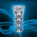 A futuristic, transparent cylindrical object with intricate internal structures, highlighted against a vibrant blue background with dynamic swirling blue light trails. The "All Nighter Glow in the Dark Textured Clear Self Lubricating Stroker" by Blush features a discreet, metallic-hued design with multiple segmented sections and textured surfaces.