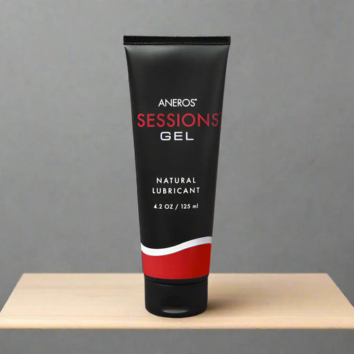 A black tube labeled "Aneros Sessions Water Based Gel Lubricant, 4.2 oz / 125 ml" with white and red accents stands upright on a white background, featuring a long-lasting, water-based gel formula.