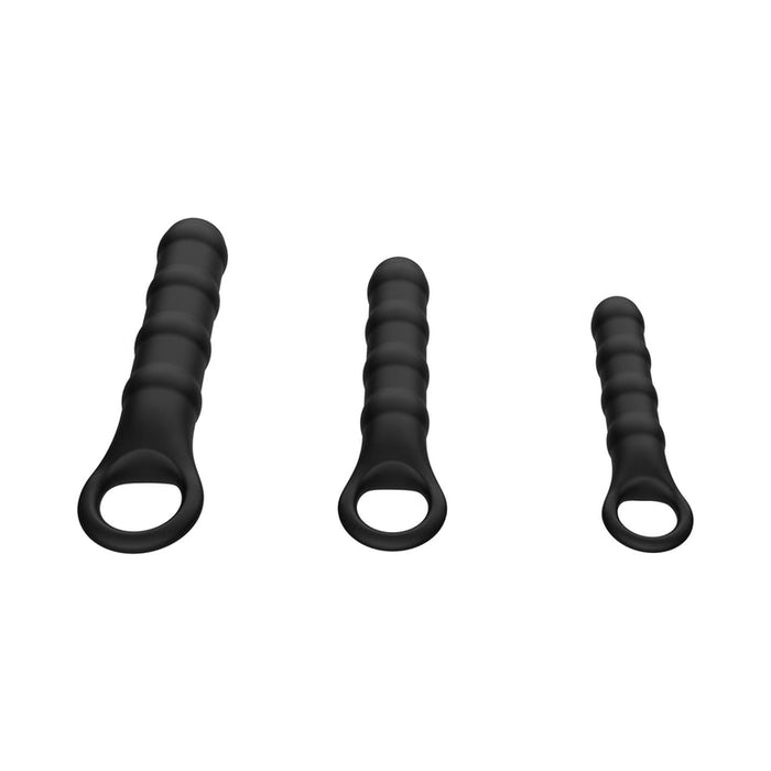 The Ass-Sation Silicone Anal Wand Training Kit features three black, ribbed silicone wands with rounded tips and large circular handles, arranged from largest to smallest—ideal as a beginner anal toys set or anal training kit on a plain white background.