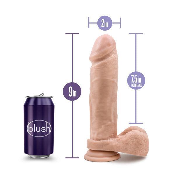 The Au Naturel Long 9.5 Inch Dual Density Light Tone Suction Cup Dildo, body-safe with balls, stands upright next to a soda can for scale. It measures 9" tall, 2" wide, and has a 7.5" insertable length as shown by the measurement graphics.
