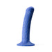 The Bae Slim Smooth 6 Inch Silicone Suction Cup Dildo, featuring a blue, speckled design with a curved shape and flared base, stands upright on a white background—ideal for strap-on play.
