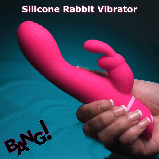 A hand holds the Bang Silicone Rabbit Vibrator with G-Spot Stroking Motion, featuring a bright pink silicone body, curved design, and rabbit-ear attachment; "Bang Silicone Rabbit Vibrator" is at the top and "BANG!" at the bottom left.