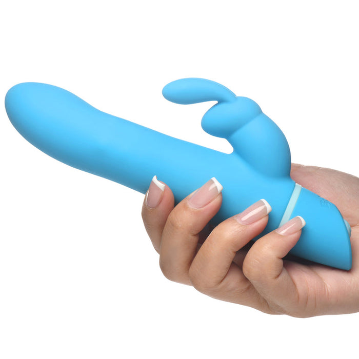 A hand holds the Bang Silicone Rabbit Vibrator with Rotating Beaded Shaft, featuring dual independent motors, a blue curved shaft, and a rabbit ear clitoral stimulator for internal and external pleasure.