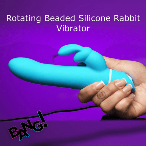 A hand holds a Bang Silicone Rabbit Vibrator with Rotating Beaded Shaft, featuring dual independent motors for internal and external stimulation, against a purple background. "BANG!" logo appears in the lower left corner.
