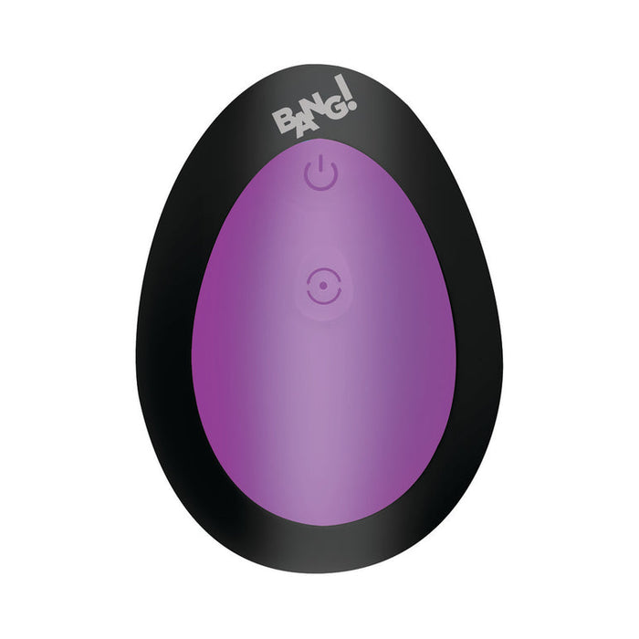 The Bang Thrusting Silicone Butt Plug with Remote Control is an oval-shaped black and purple anal vibrator featuring a power button symbol in the center, "BANG!" at the top, and a white background.