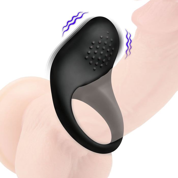 The Bang Beginner-Friendly Vibrating Silicone Cock Ring for Couples, in black, wraps around an erect penis with textured bumps for clitoral stimulation. Wavy lines illustrate vibration on a white background, emphasizing shared pleasure.