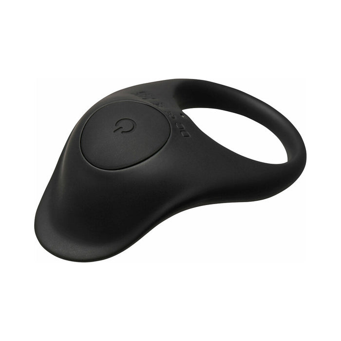 The Bang Beginner-Friendly Vibrating Silicone Cock Ring for Couples is a black, oval silicone ring with a large circular button and power symbol, designed for wearable clitoral stimulation and shared pleasure.
