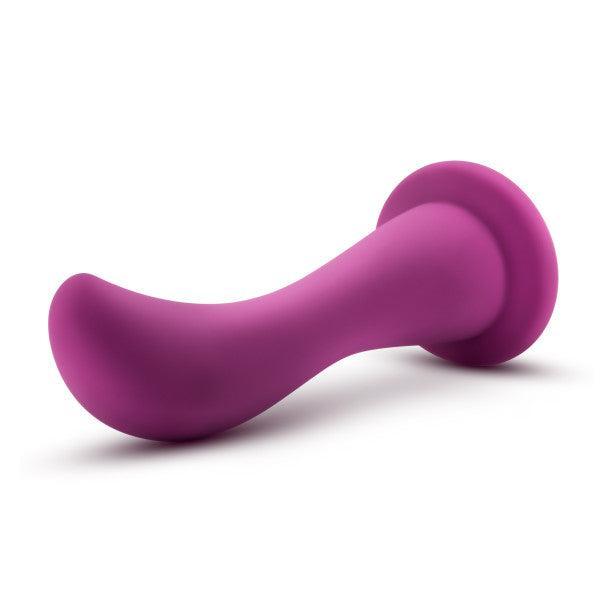 The Bellatrix Slim Curved 6.25 Inch Purple G-Spot and Prostate Dildo with Suction Cup features a curved shaft for targeted stimulation and a flared base, shown against a white background.