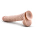 The Big Daddy 14 Inch Dual Density Suction Cup Dildo - Vanilla by Blush is a realistic, flesh-colored dildo that mimics the appearance and feel of a human penis with its veined texture and strong suction cup base. The toy is displayed lying on a white surface.