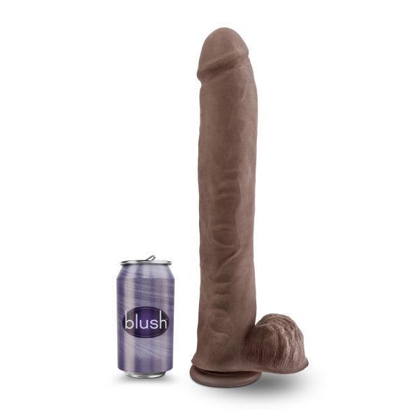 The Big Daddy Huge 14 Inch Dual Density Dark Tone Suction Cup Dildo stands upright next to a purple soda can labeled "blush" for size comparison.