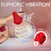 A hand with red nails holds the Bloomgasm Rose Ring Finger Vibrator, a small rose-shaped, body-safe silicone wearable. Water splashes and spiral lines show vibration. Text: "EUPHORIC VIBRATION," "7 Patterns," "3 Speeds.