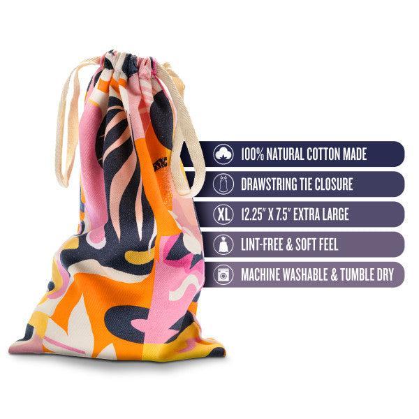 The Blush Burst Colorful Toy Storage Bag, featuring a vibrant pink, orange, black, and white pattern with a drawstring tie closure, is displayed. Text alongside highlights its features: "100% Natural Cotton Made, XL 12.25” x 7.5” Extra Large, Lint-free & Soft Feel, Machine Washable & Tumble Dry." Perfect for sex toy storage or as a cotton toy bag.