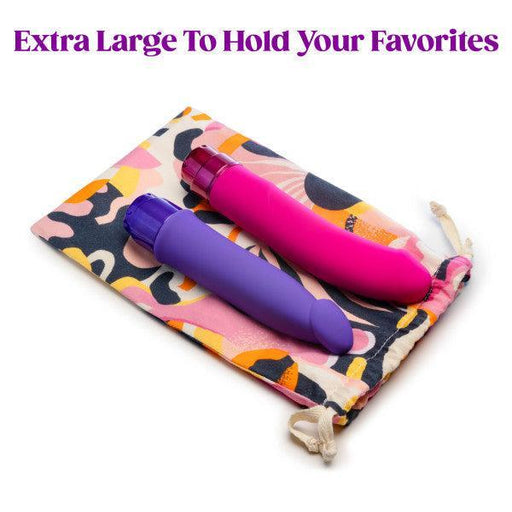 Two vibrators, one purple and one pink, are placed on top of the Blush Burst Colorful Toy Storage Bag from Blush, featuring a playful pattern of abstract shapes. Made from natural cotton, this sex toy storage bag is machine washable. A bold purple text above the items reads "Extra Large To Hold Your Favorites.
