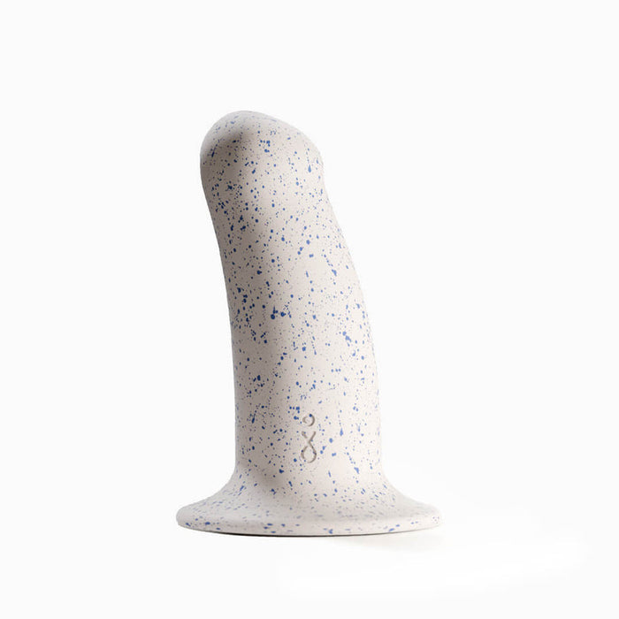 The Boo Thick Smooth 5.5 Inch Silicone Suction Cup Dildo is a white, curved toy with a wider shaft, blue speckles, and a flat suction cup base. Made of body-safe silicone with a smooth surface and small embossed design, shown against a plain white background.
