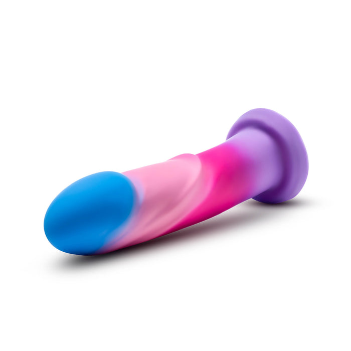 The Borealis Dreams Girthy Textured 7.75 Inch Silicone Dildo features a blue tip, pink and purple shaft, flared base for strap-on harness compatibility, and is shown on a white background.
