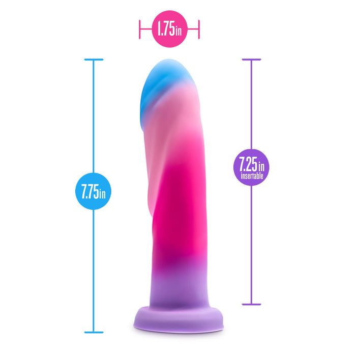 The Borealis Dreams Girthy Textured 7.75 Inch Silicone Dildo features a swirled pink, blue, and purple design, measures 7.25 inches insertable by 1.75 inches wide, has a suction cup base, and is harness compatible.