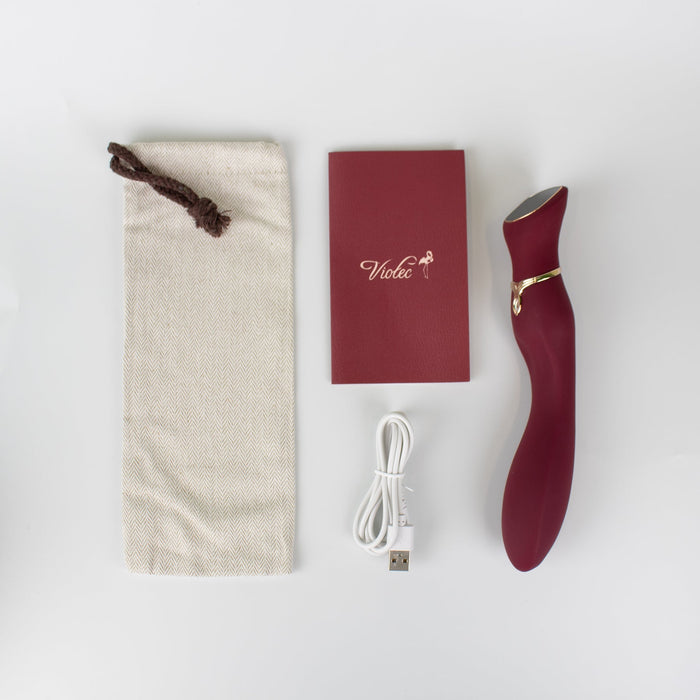 The Chance Waterproof Touch Screen G-Spot Vibrator, made of medical-grade silicone in maroon, is displayed with a beige drawstring pouch, USB charging cable, and red instruction manual on a white surface.