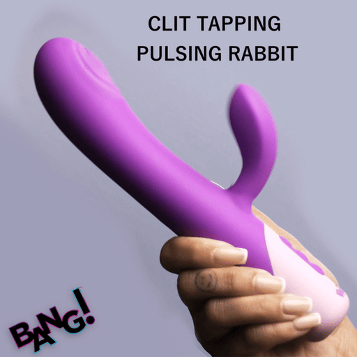 A hand holds the Clit Tapping G-Spot Pulsing Rabbit Flexible Silicone Vibrator in purple and pink. The text says “CLIT TAPPING PULSING RABBIT,” highlighting its clitoral stimulator. “BANG!” is boldly displayed in the bottom left corner.