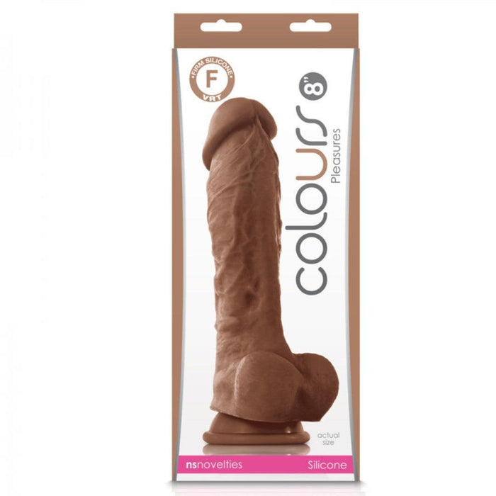 The Colours Realistic Long 9.5 inch Medium Tone Silicone Dildo, made of premium silicone, features a lifelike design and harness compatibility. It's displayed vertically in its packaging, emphasizing its realistic look and quality details.