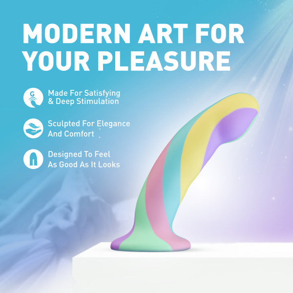 The Daydream Smooth Slim Silicone Dildo with Suction Cup, in pastel rainbow hues, sits on a white platform. Its body-safe silicone and elegant design promise comfort, satisfaction, and visual appeal against a dreamy backdrop.