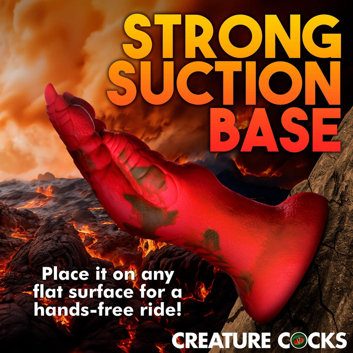 The Demon Claw Long Thick Fantasy Fisting Silicone Dildo by Creature Cocks, a red dragon-inspired toy with bold "STRONG SUCTION BASE" text, stands upright on rock, perfect for adventurous pleasure seekers.