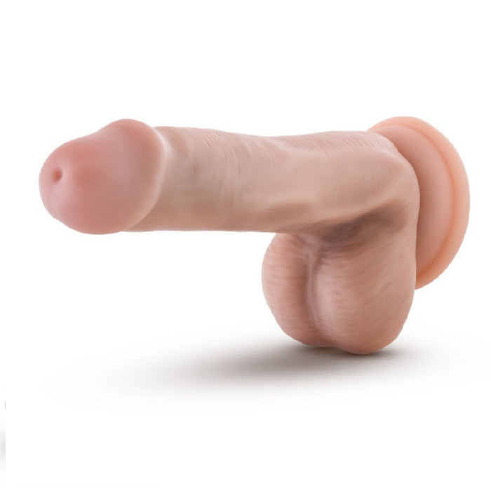 A Blush Dr. Daniel 6 Inch Beginner Suction Cup Dildo - Vanilla made from platinum-cured silicone, designed to resemble a human penis and scrotum, displayed against a plain white background.