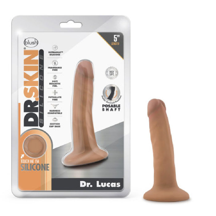 The Dr. Lucas Lifelike 5 Inch Beginner Medium Tone Silicone Dildo with Suction Cup is displayed in and out of its packaging. This posable dildo features a suction cup base and is harness compatible.