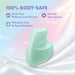 The Dream Crush Waterproof Ergonomic Finger Vibrator, in mint green, made from 100% body-safe, platinum-cured silicone with an UltraSilk satin smooth finish, is phthalate-free and hypoallergenic—shown on a silky white surface with a pastel sky background.