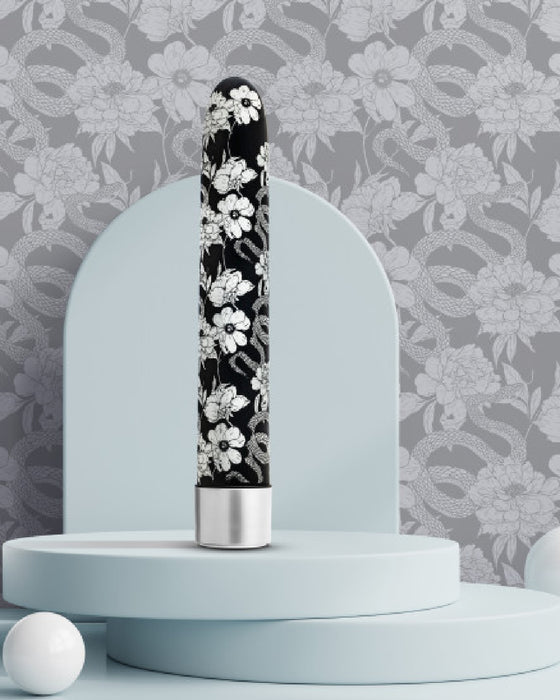 Eden Black Floral Slim Beginner Bullet Vibrator on grey platofrm with grey wallpaper 