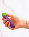 Eggplant Emojibator Vibrator in model's hand with love tattoo 