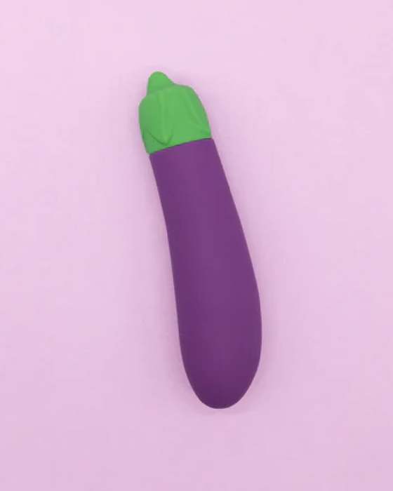 Eggplant Emojibator Vibrator upright on purple background 