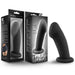 The Elvira Short Thick Smooth 6 Inch Suction Cup Dildo in Black Silicone, featuring a girthy flexible shaft and flared base for internal stimulation, is shown beside its packaging with product images, branding, and descriptions.