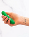 Pickle Emojibator Vibrator in model's hand with love tattoo on wrist 