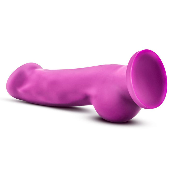 The Ergo Semi-Realistic 7.5 Inch Purple Silicone Suction Cup Dildo features a realistic shape and flared suction base, ideal for strap-on harness use, shown here against a white background.