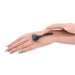 A French-manicured hand gently glides the Ex's & Oh's Temperature Play Sensory Roller over another manicured hand, inviting intimate exploration against a white background.