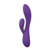 The Fever Dream Beginner G-Spot Rabbit Vibrator is a purple silicone toy with a curved main shaft and angled extension for G-spot and external stimulation. It’s beginner-friendly, features a smooth surface, and has a visible power button at the base.