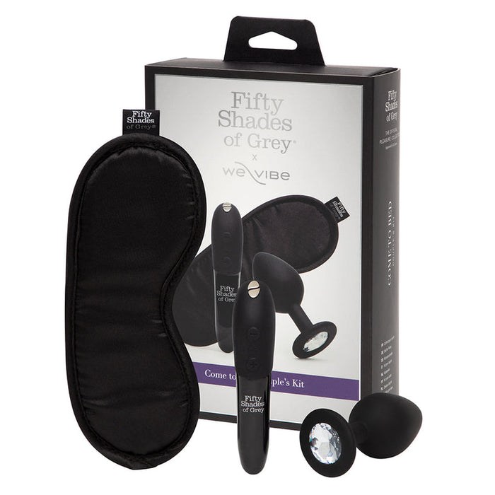 The Fifty Shades of Grey Come to Bed Kit includes a black blindfold, vibrating plug, vibrator, and jeweled butt plug—ideal for couples' sensual exploration, all displayed in front of the product packaging.