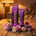 A purple tube and box of Wicked Awaken Stimulating Clitoral Gel .3oz rest on a rustic wooden table among colorful flowers, creating a cozy, softly lit ambiance that enhances clitoral sensitivity.