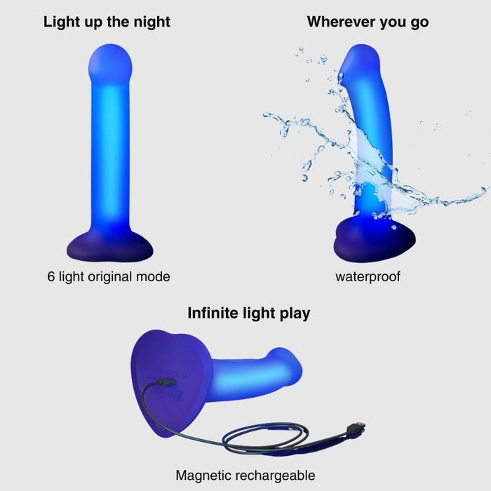 The Glow Light Up Blue LED 7 Inch Silicone Dildo is shown glowing, splashed with water to highlight its waterproof feature, and charging with a magnetic cable. Text notes its LED glow modes and strap-on harness compatibility.