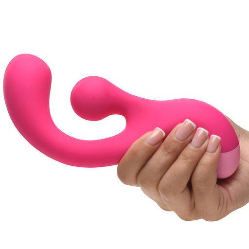 A hand holds the Gyro Rabbit Flexible Silicone Vibrator, a pink, curved silicone toy with an ergonomic design and a rotating clitoral stimulator for dual stimulation.