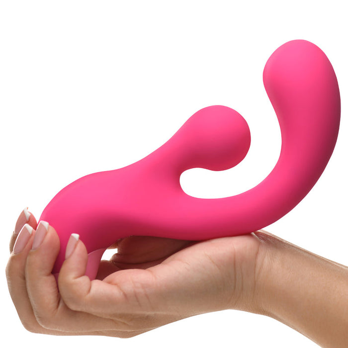 A hand holds the Gyro Rabbit Flexible Silicone Vibrator, featuring bright pink, curved silicone and a rotating clitoral stimulator for intense internal and external pleasure.