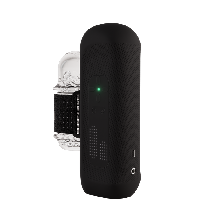 The Handy 2 Interactive Automatic Masturbator is a sleek black male sex toy with a textured surface, control buttons, LED indicator lights, charging port, and comes with a transparent curved accessory featuring a black band.