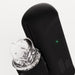 Close-up of The Handy 2 Interactive Automatic Masturbator in sleek black with a glowing green indicator light and control buttons, shown beside its transparent dome-shaped component, on a white background.